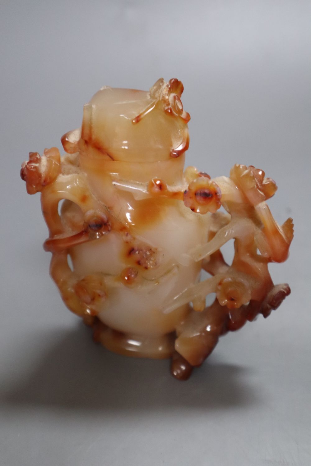 A Chinese agate vase and cover and a hardstone tree, in carved celadon jardiniere, 29cm